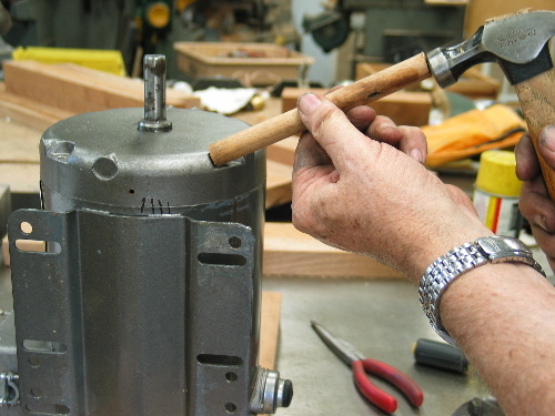 Tap on a stick to rotate end bells for proper alignment and assemble motor