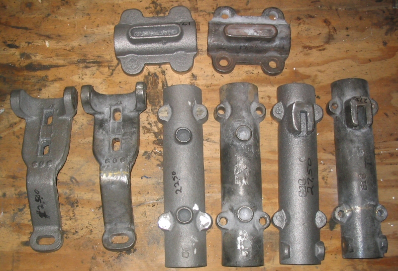  The new castings next to the repaired parts used as patterns as received from Cattail foundry 