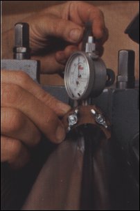A cutterhead gauge enables knives to be set consistently to within one or two thousandths of an inch. The wing nuts on the base allow plunger height adjustment. 