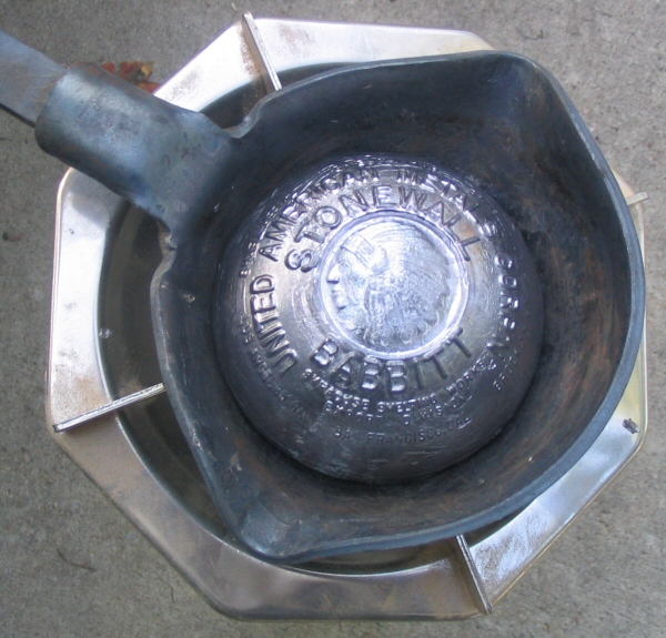  The ingot of babbitt metal melting on the camp stove 